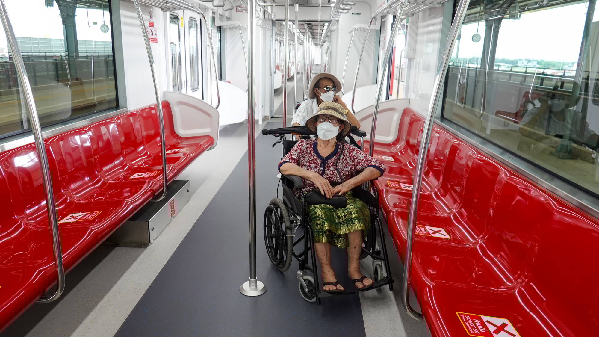 identifiable disabled person in wheelchair, inside the train.